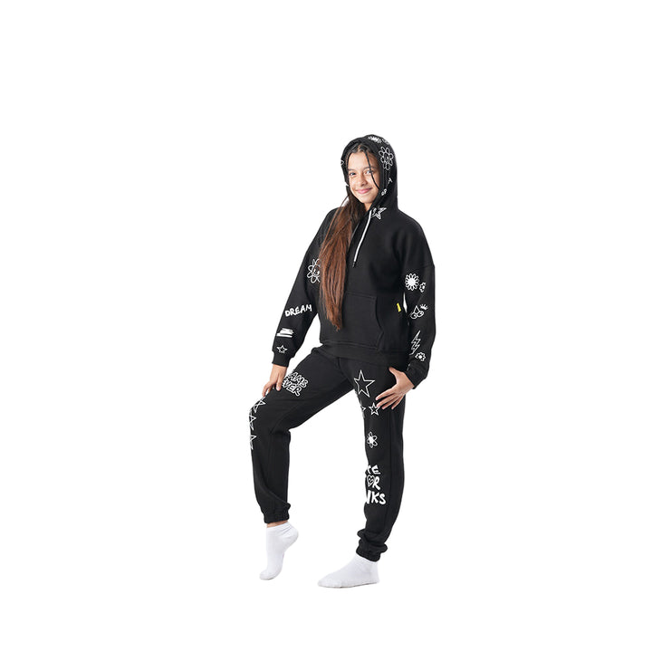 Person wearing a black tracksuit with white designs on a white background