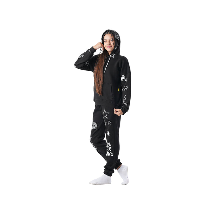 Person wearing a black hoodie and pants with white text and designs on a white background