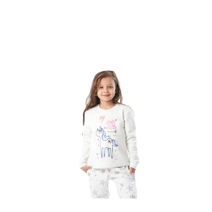 Young girl wearing a white sweatshirt with a colorful design on a white background