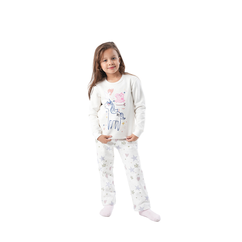Child wearing a white pajama set with cartoon designs on a white background
