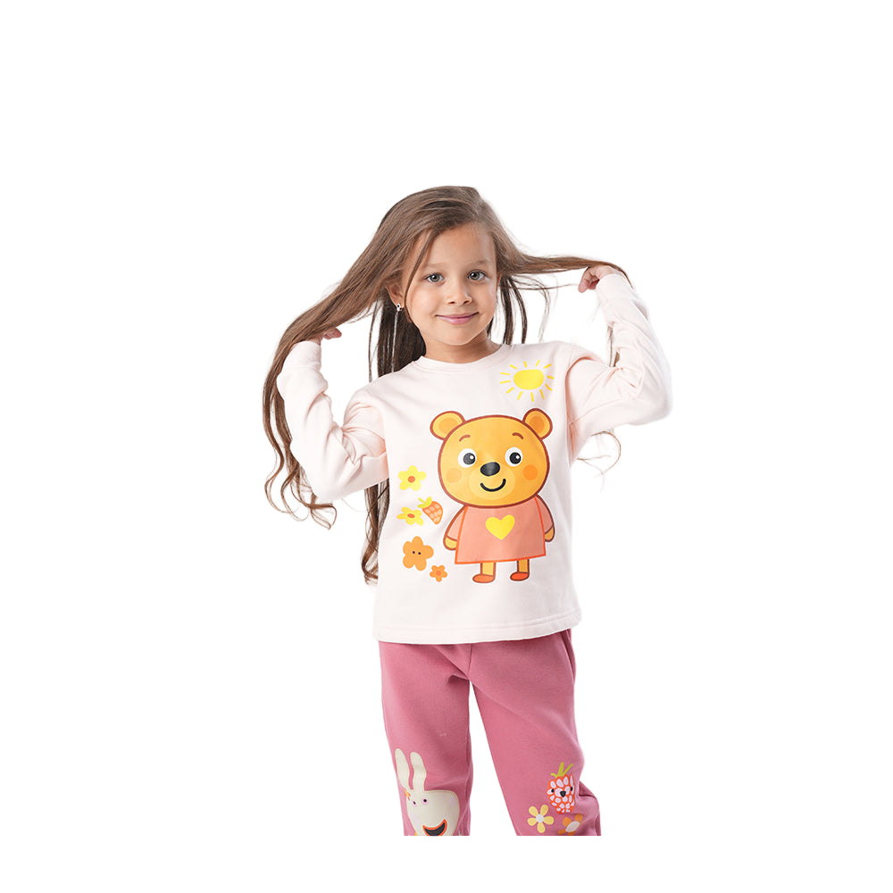 Child wearing a white shirt with a cartoon bear design and pink pants 