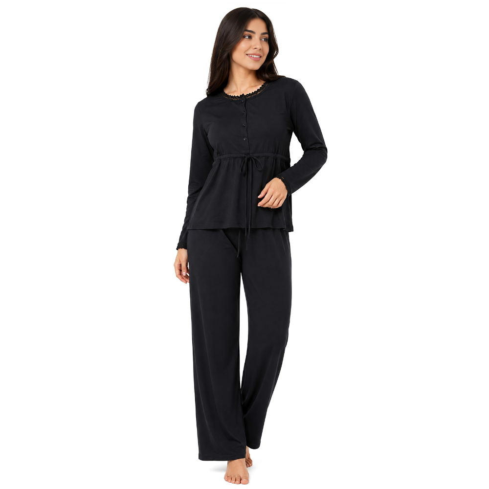 A woman modeling a black two-piece pajama set consisting of a long-sleeve button-front top with a drawstring waist and matching wide-leg pants, photographed against a plain white background.