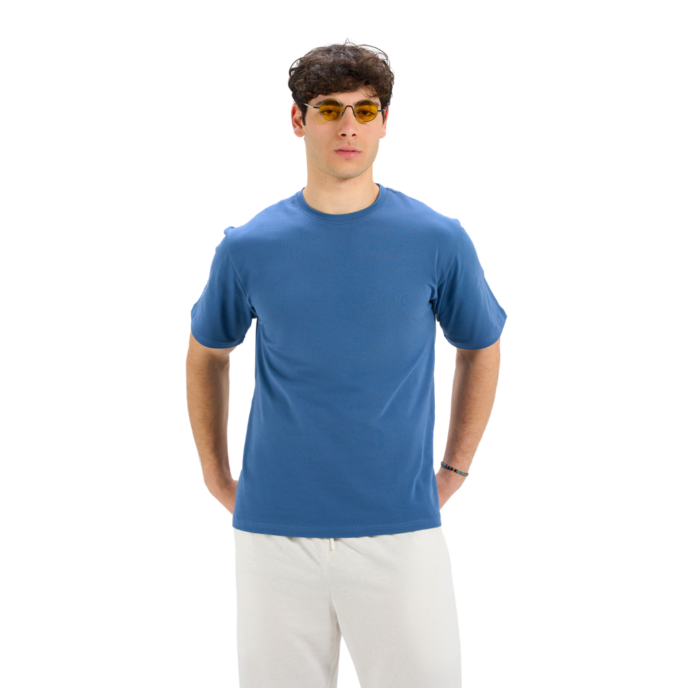 Man wearing a blue t-shirt and sunglasses on a white background