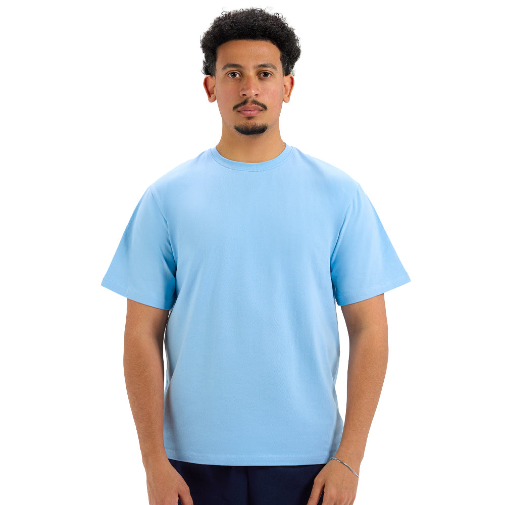 Man wearing a light blue t-shirt on a white background