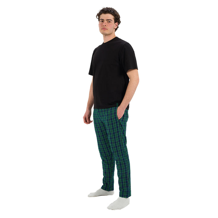 Man wearing a black t-shirt and green plaid pants on a white background