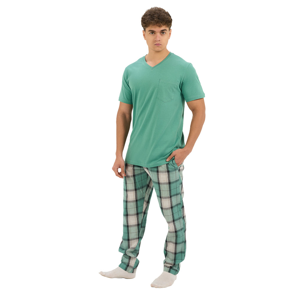 Man wearing a green t-shirt and plaid pants on a white background