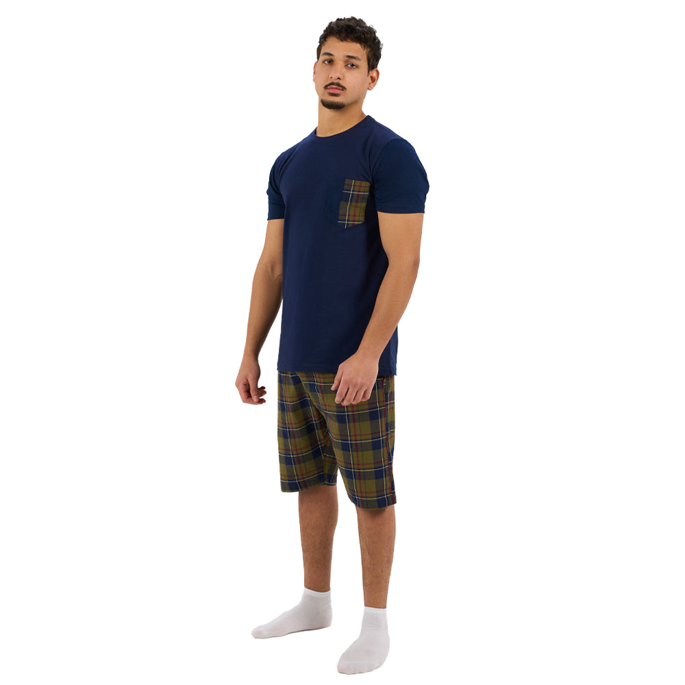 Man wearing a navy t-shirt with plaid pocket and shorts on a white background