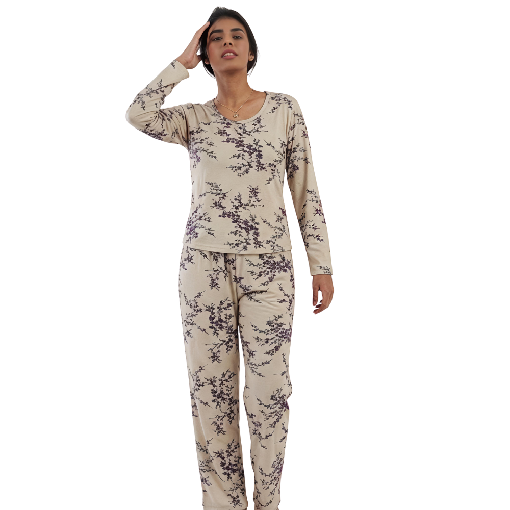 Woman wearing a floral pajama set on a white background